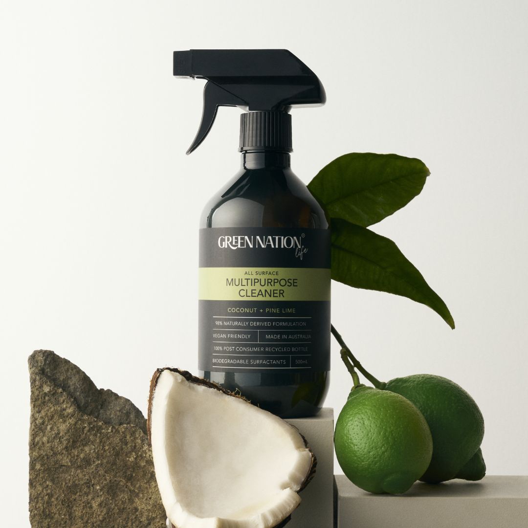 Green Nation Life multipurpose cleaner bottle with coconut, limes, leaves, and stone accents