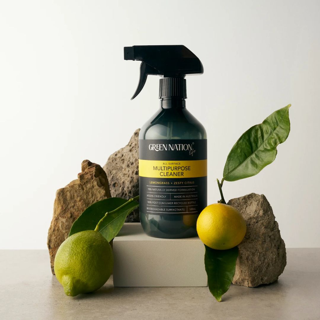 Green Nation multipurpose cleaner with lemons, leaves, and rocks on a neutral background