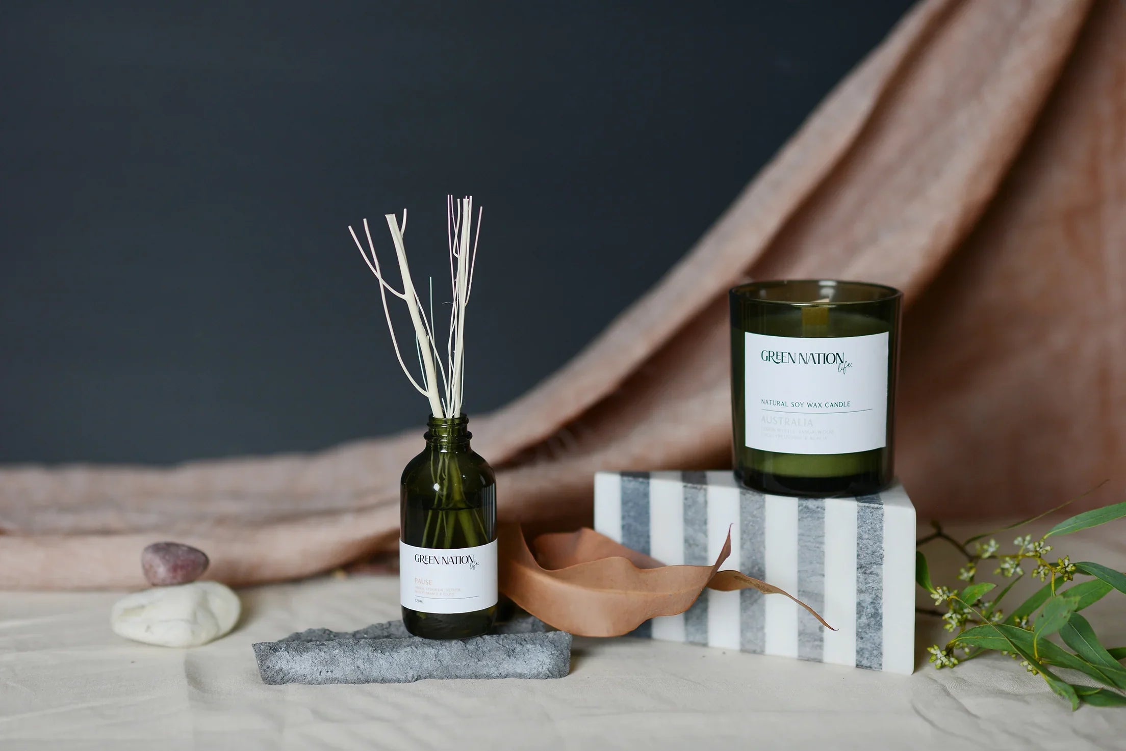 Green Nation Life soy candle and reed diffuser in green glass bottles on neutral background