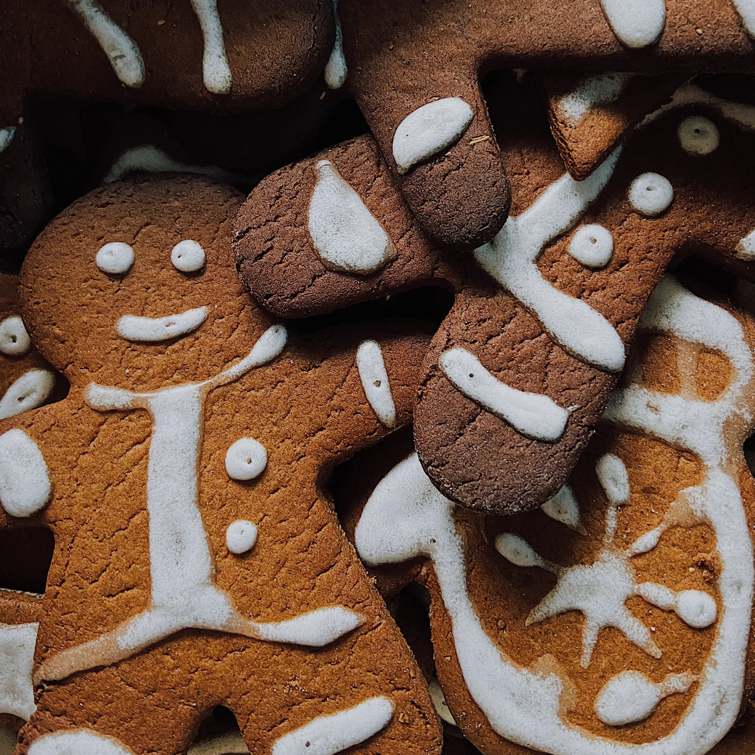 Gingerbread cookies with white icing in festive holiday shapes, close-up view